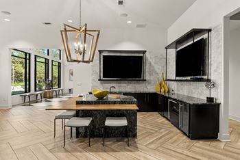 A modern kitchen with a black countertop and a large island.